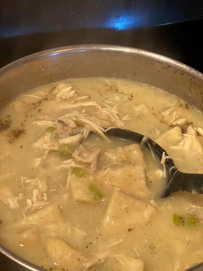 flat dumplings simmering in chicken broth