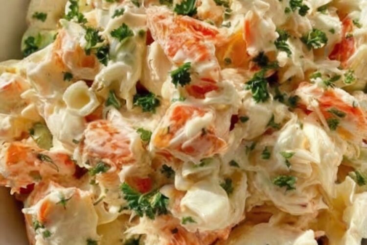 Creamy crab salad with celery and herbs in a bowl