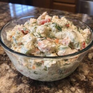 Creamy crab salad with celery and herbs in a bowl