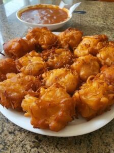 Crispy Amish onion fritters freshly fried and golden