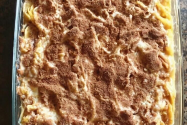 Slice of cinnamon kugel with golden cinnamon sugar top