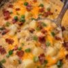 Creamy crockpot potato soup topped with bacon cheddar and sliced green onions