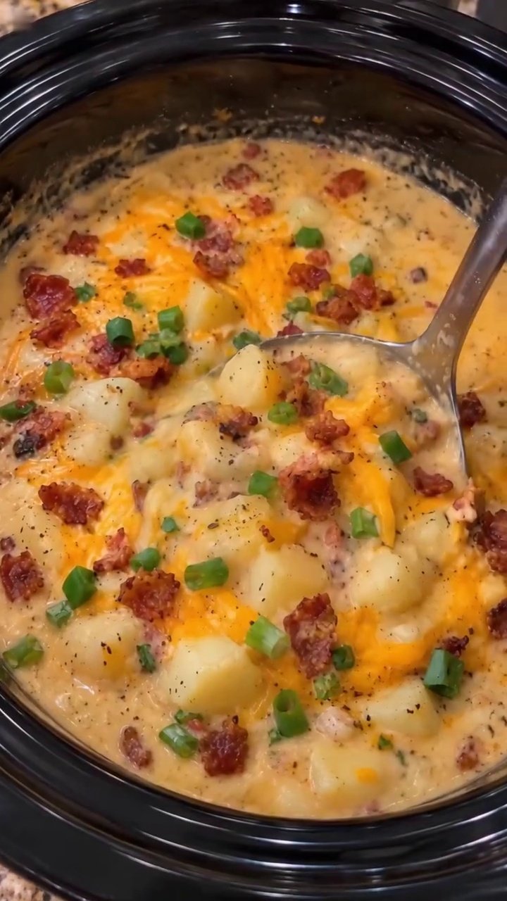 Creamy crockpot potato soup topped with bacon cheddar and sliced green onions