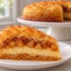 A slice of apple and custard kataifi pie showing golden pastry, vanilla custard, and cinnamon apples.