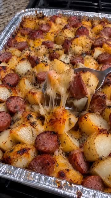 Cheesy potato and smoked sausage casserole with golden potatoes, browned sausage coins, and melted cheese