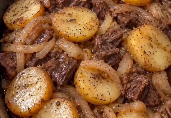 Slow cooker beef and potatoes with tender chuck, golden potato rounds, onions, and brown gravy