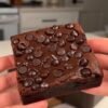Fudgy sweet potato brownie topped with dark chocolate chips, showing its dense chocolate center