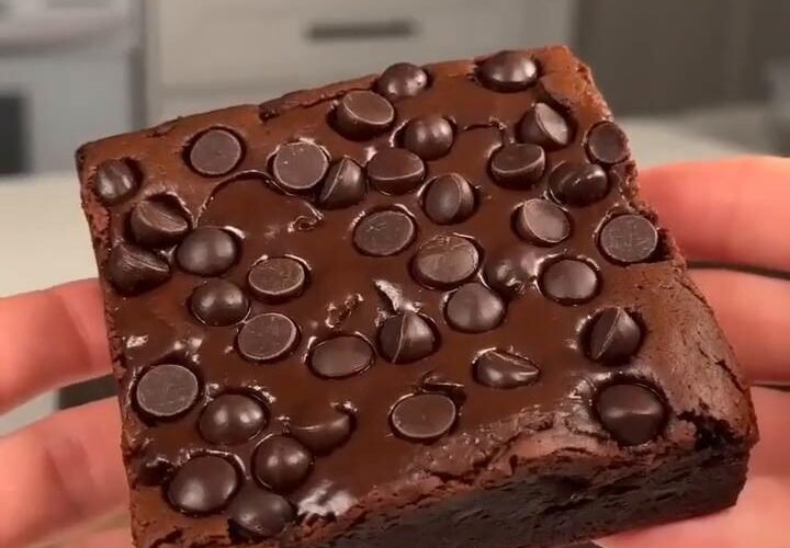 Fudgy sweet potato brownie topped with dark chocolate chips, showing its dense chocolate center